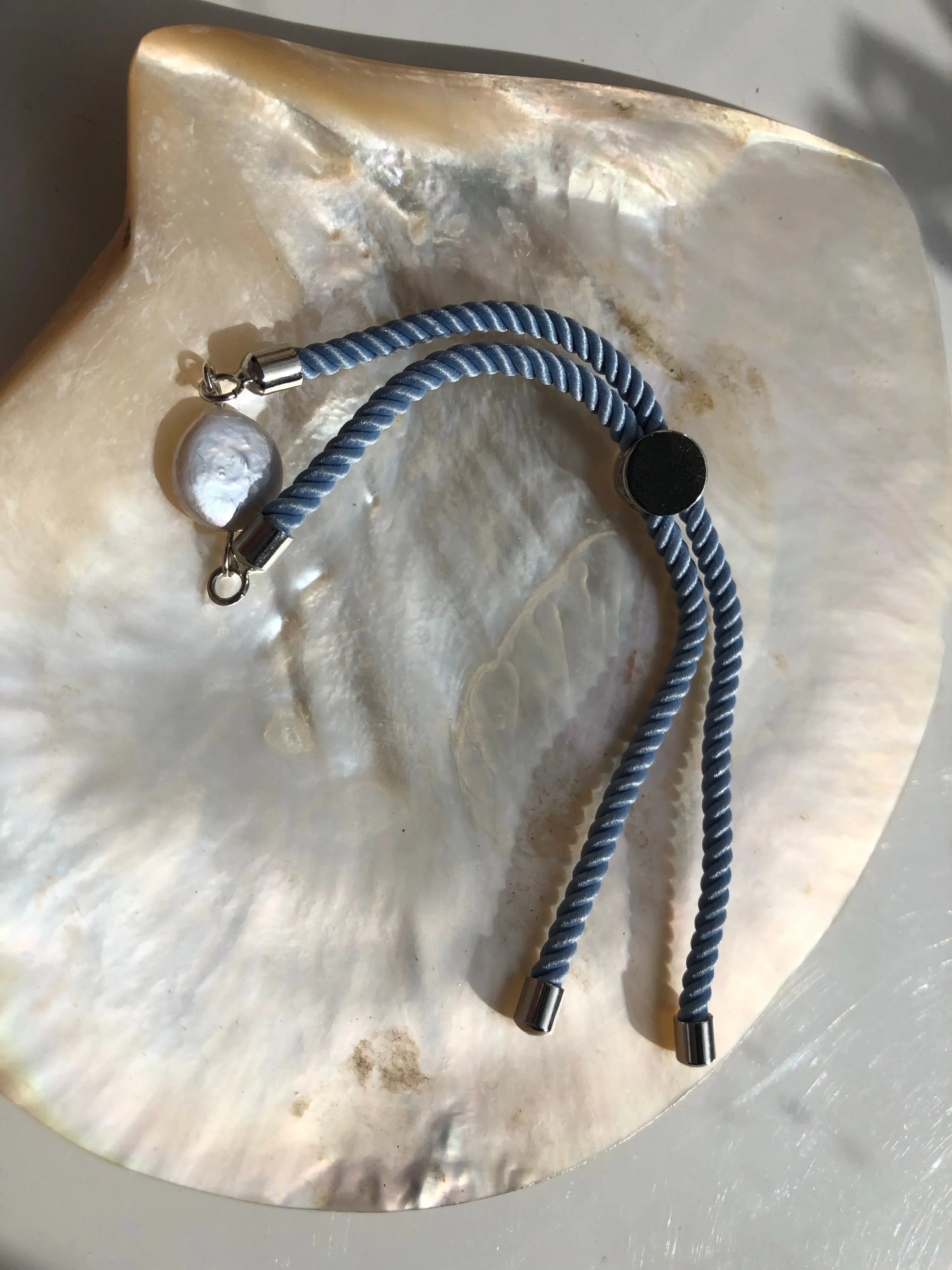 Bracelet: Pearl coin slider cord bracelets in silvertone.