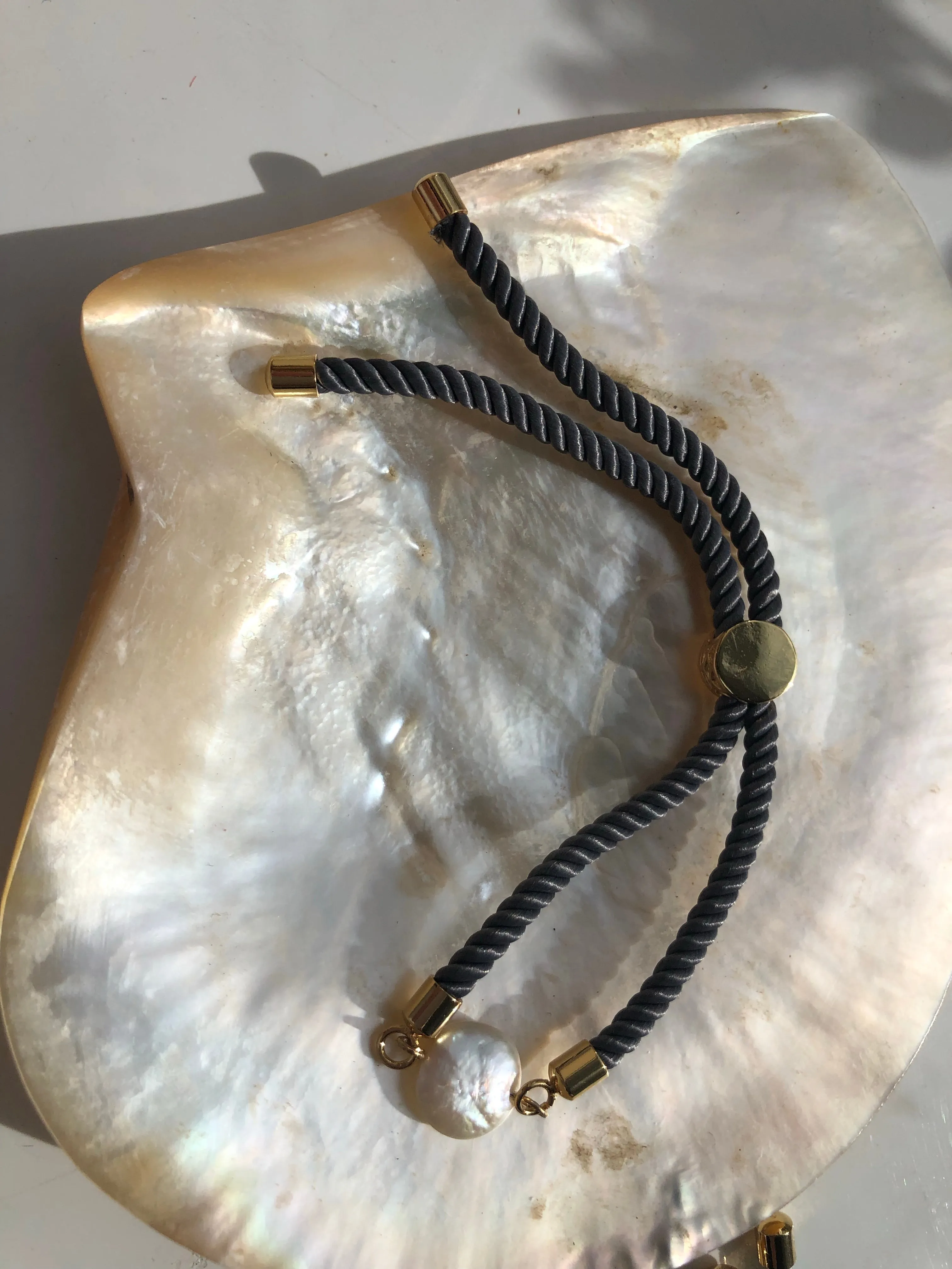 Bracelet: Pearl coin slider cord bracelets in silvertone.