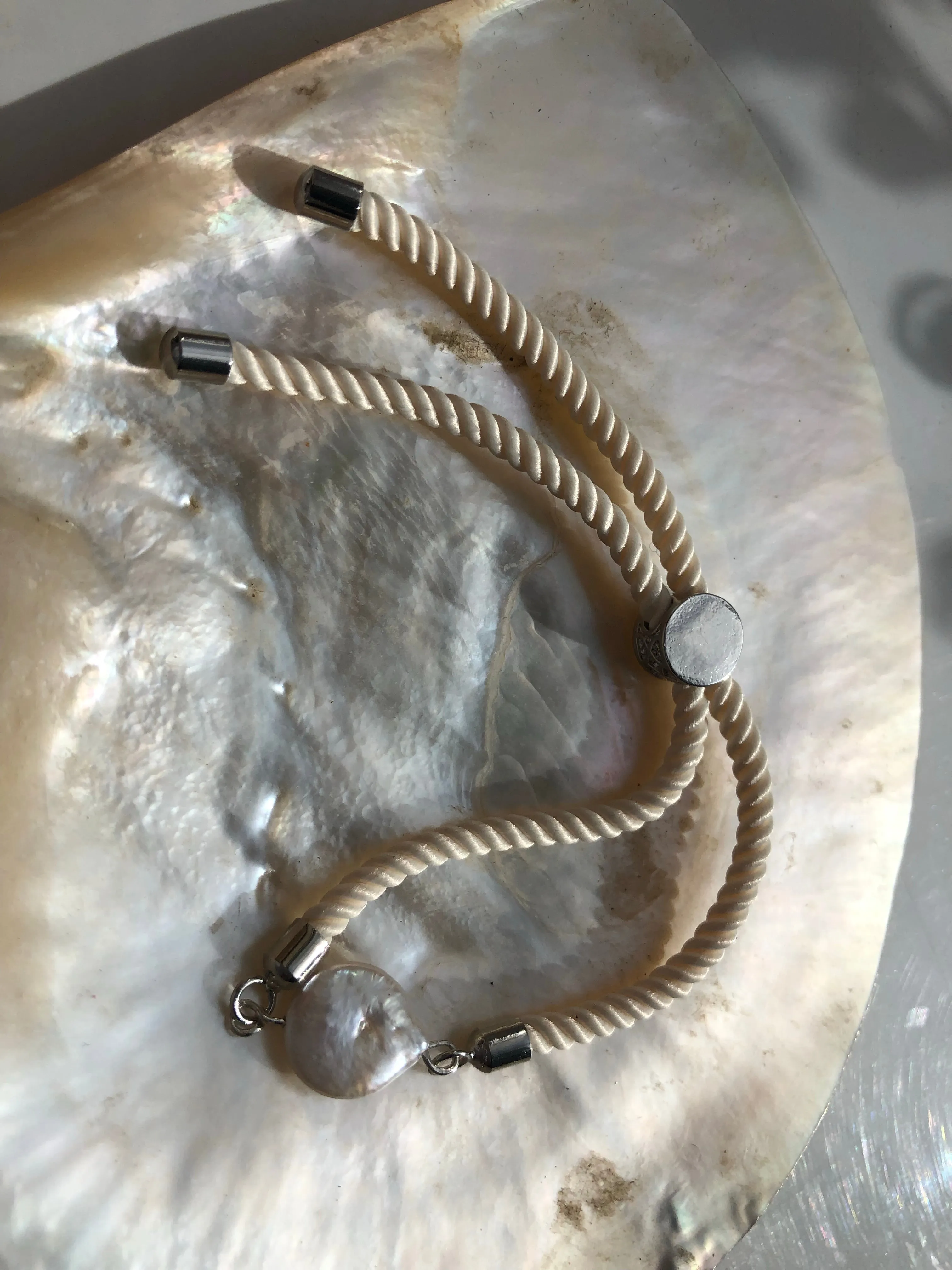 Bracelet: Pearl coin slider cord bracelets in silvertone.