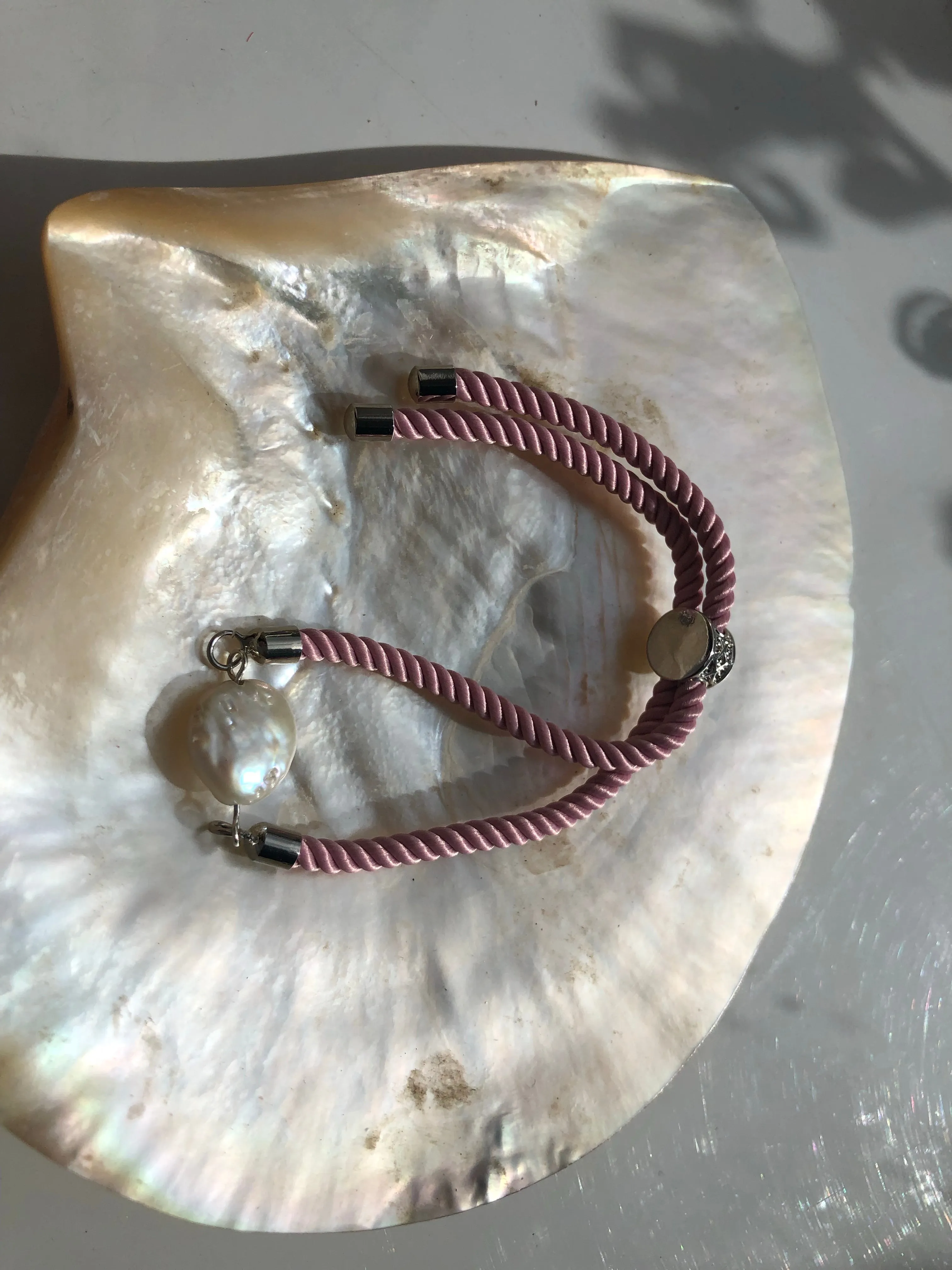 Bracelet: Pearl coin slider cord bracelets in silvertone.