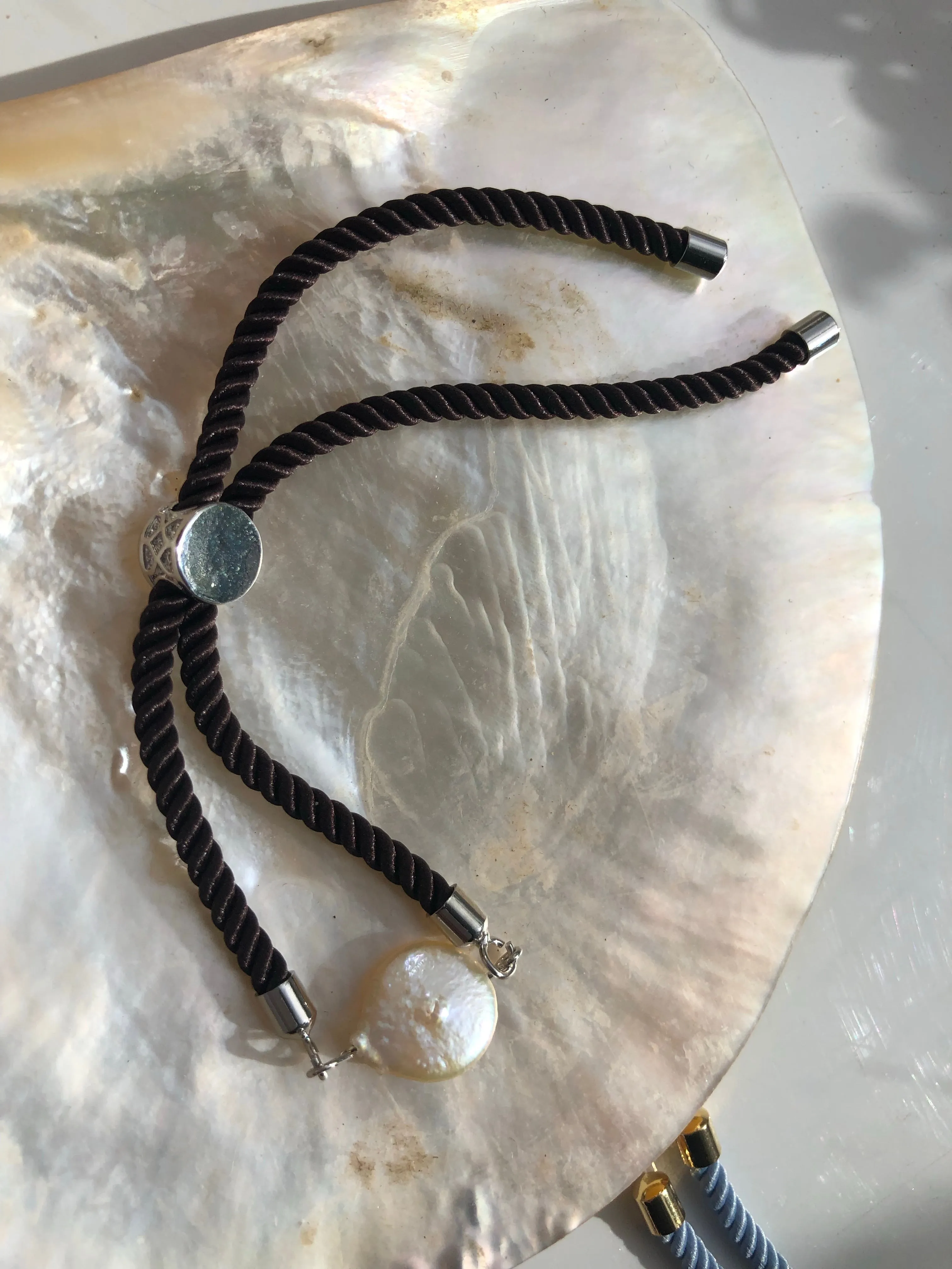 Bracelet: Pearl coin slider cord bracelets in silvertone.