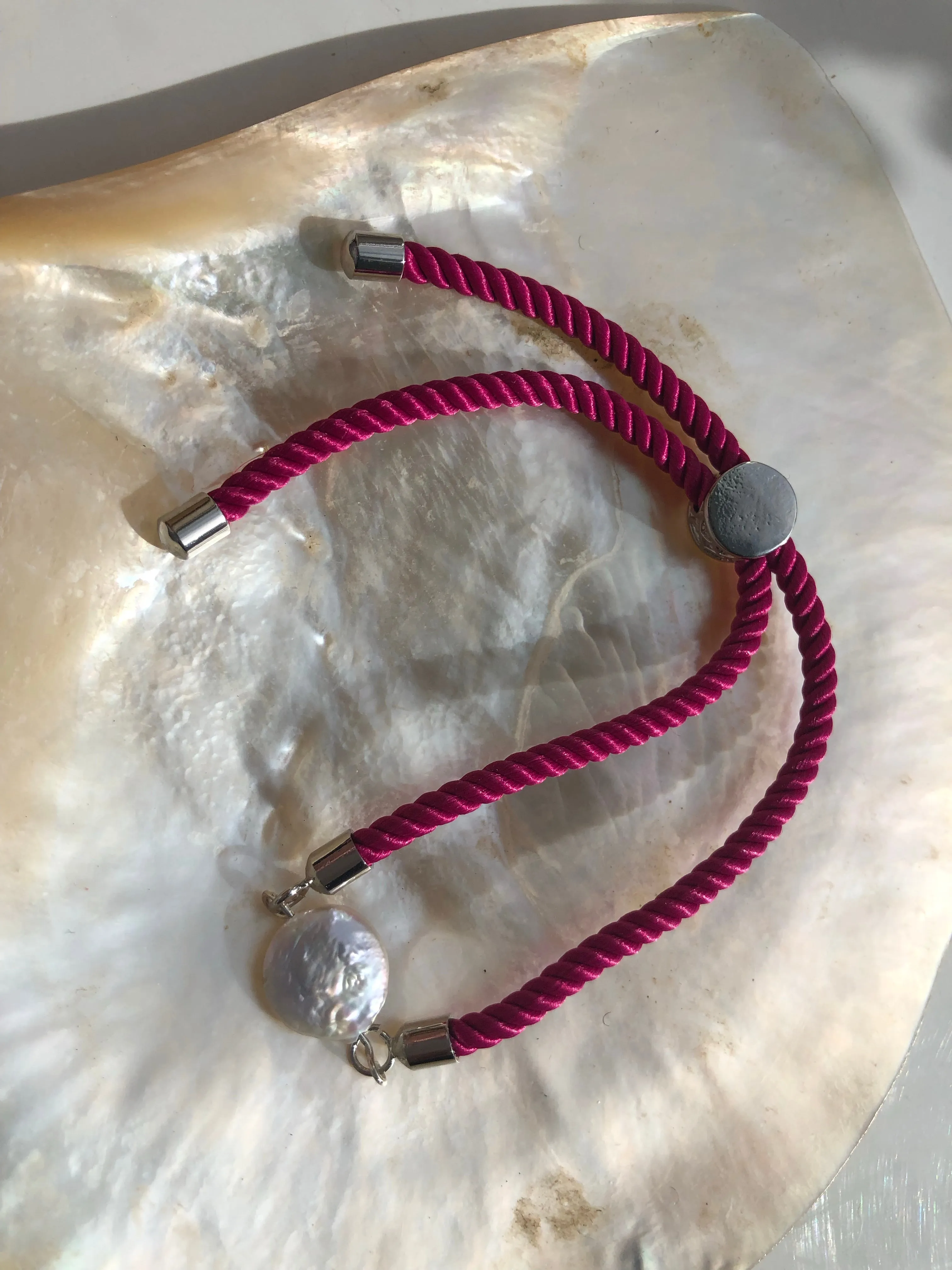 Bracelet: Pearl coin slider cord bracelets in silvertone.