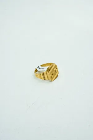 Modern gold ring with understated carvings