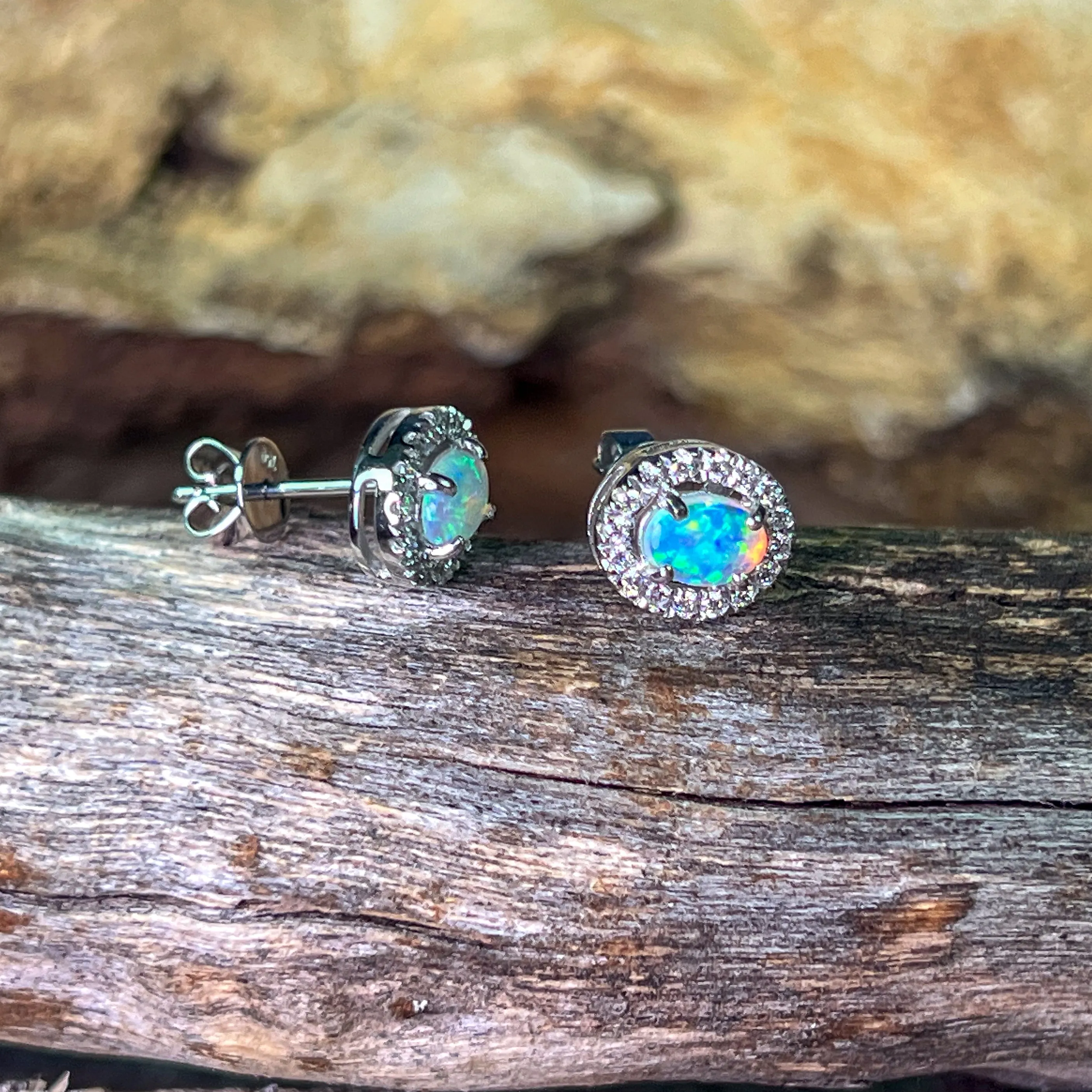 Pair of 18kt White Gold halo Opal and diamond studs