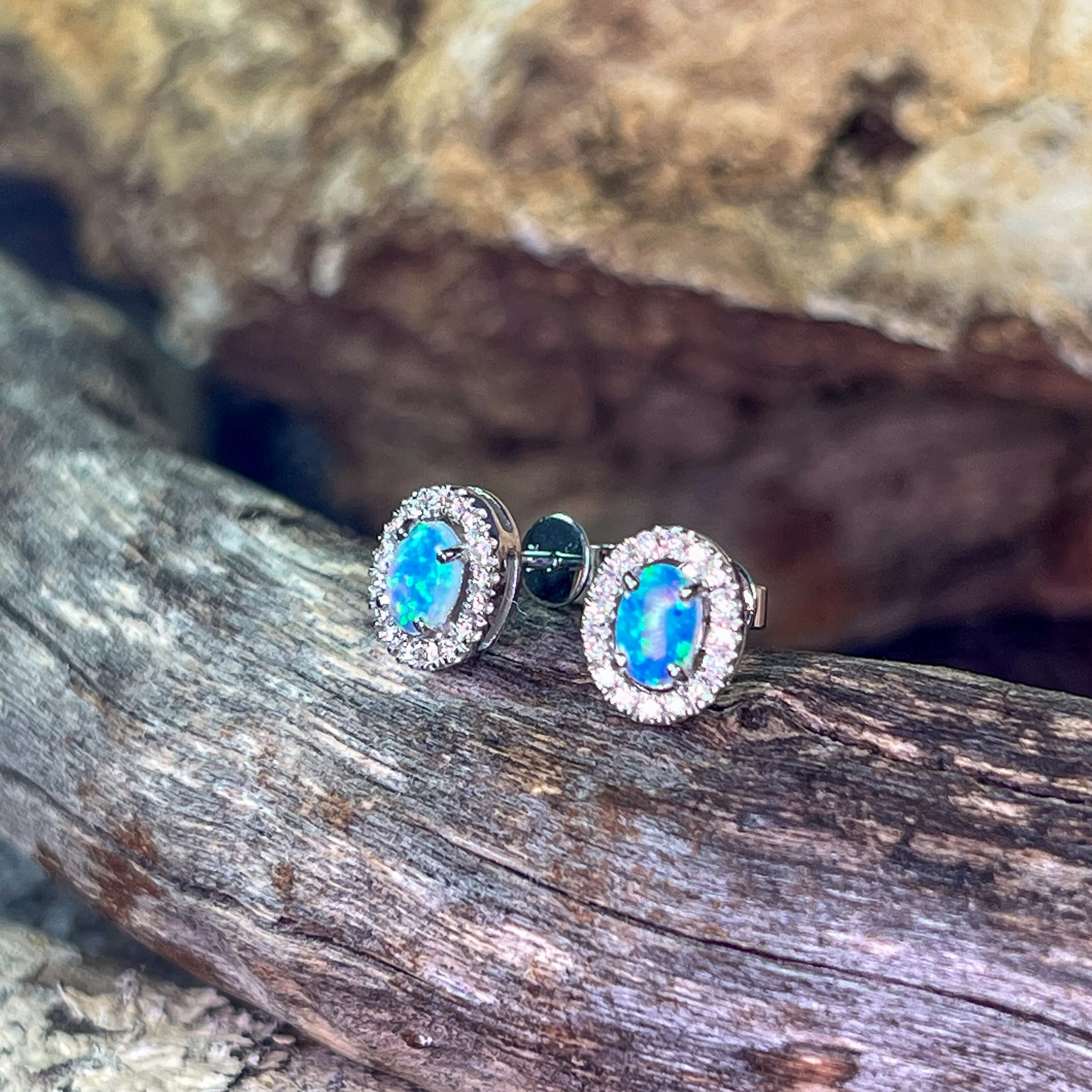 Pair of 18kt White Gold halo Opal and diamond studs