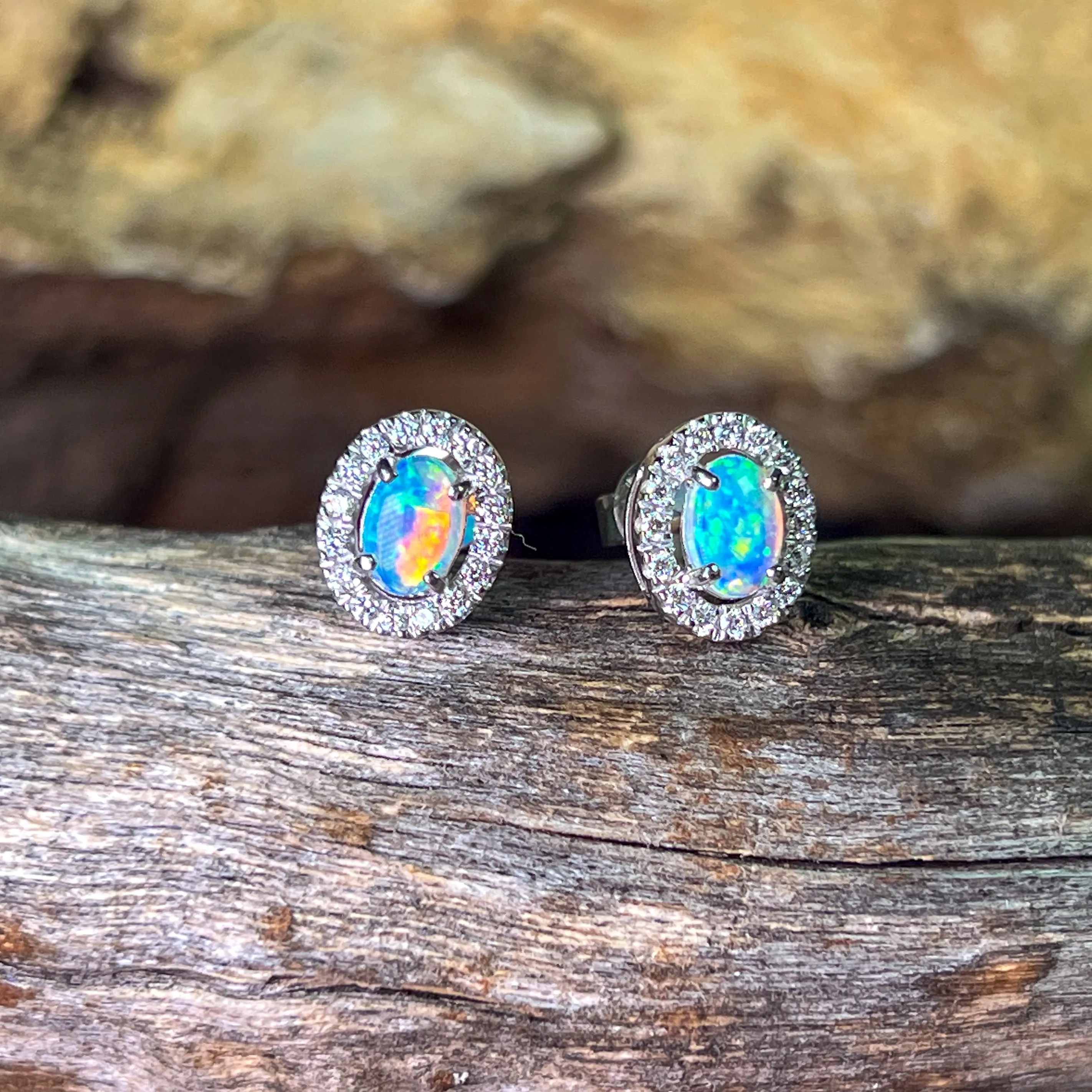 Pair of 18kt White Gold halo Opal and diamond studs