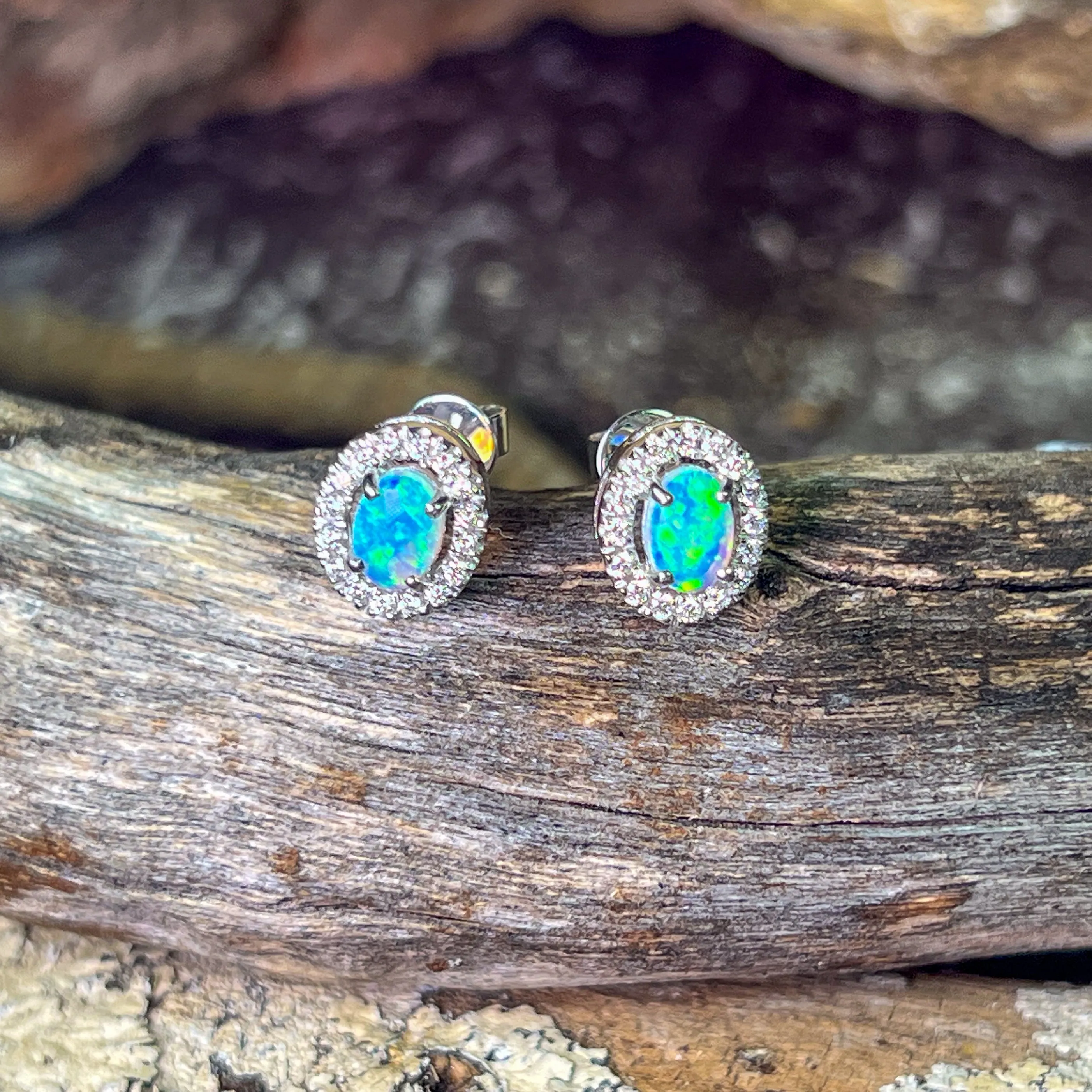 Pair of 18kt White Gold halo Opal and diamond studs