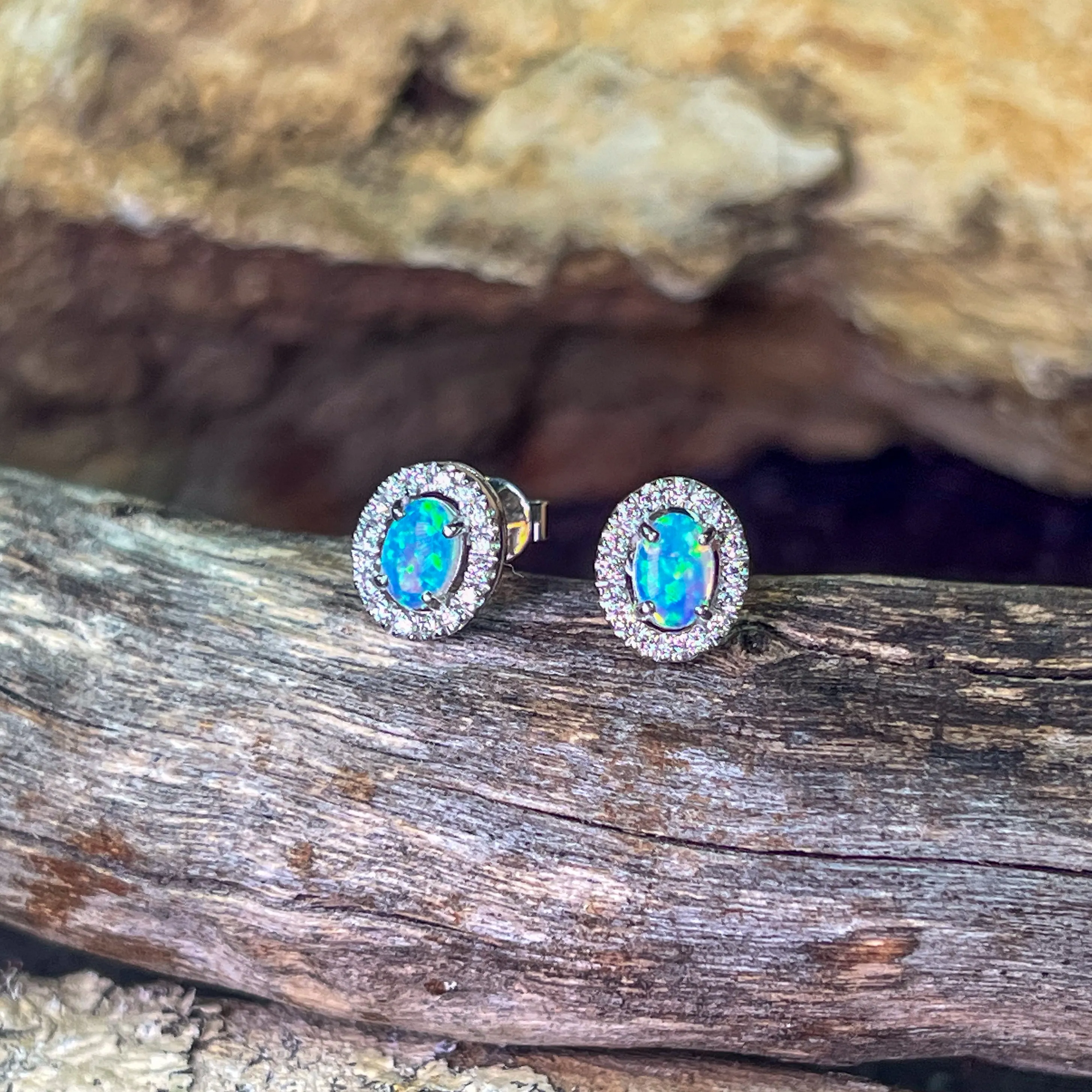Pair of 18kt White Gold halo Opal and diamond studs