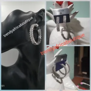 Silver tone hoop earrings with clear crystals in 18k electroplating. Top quality made hypoallergenic. Light weight earrings. Beautiful Dubai silver earrings