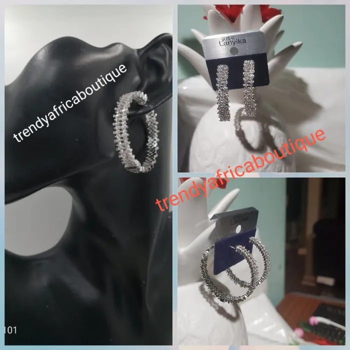 Silver tone hoop earrings with clear crystals in 18k electroplating. Top quality made hypoallergenic. Light weight earrings. Beautiful Dubai silver earrings